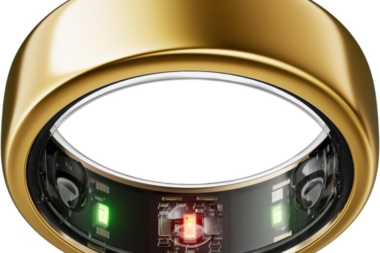 Gold smart ring with visible internal components and colored sensors