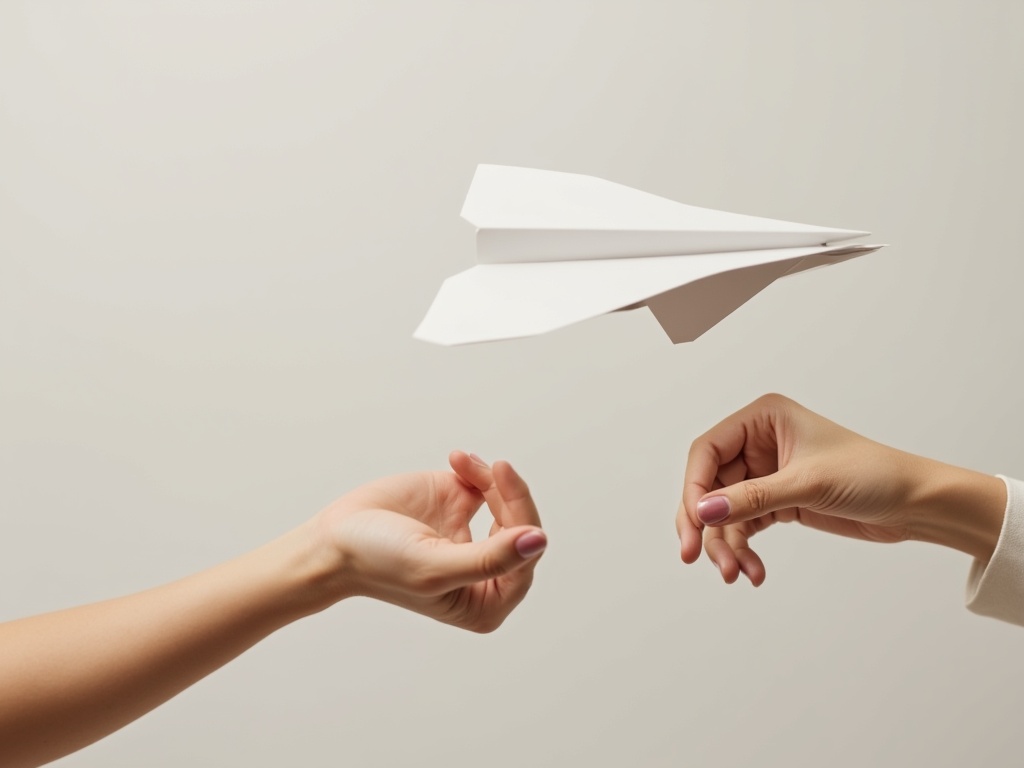 A person's hands gently releasing a paper airplane, symbolizing relinquishing control in a relationship.